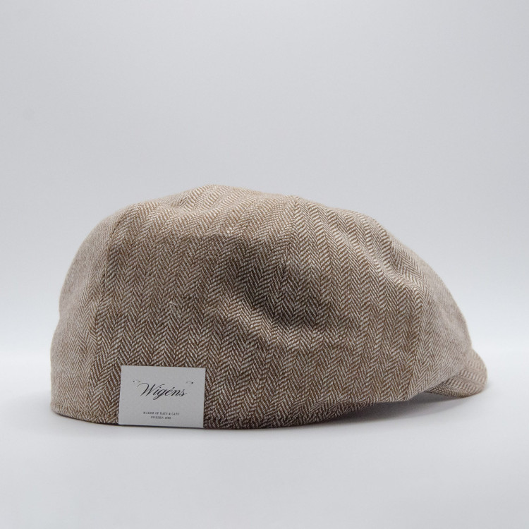 Sidovy av beigemelerad Wigéns News Boy Classic Cap med etikett