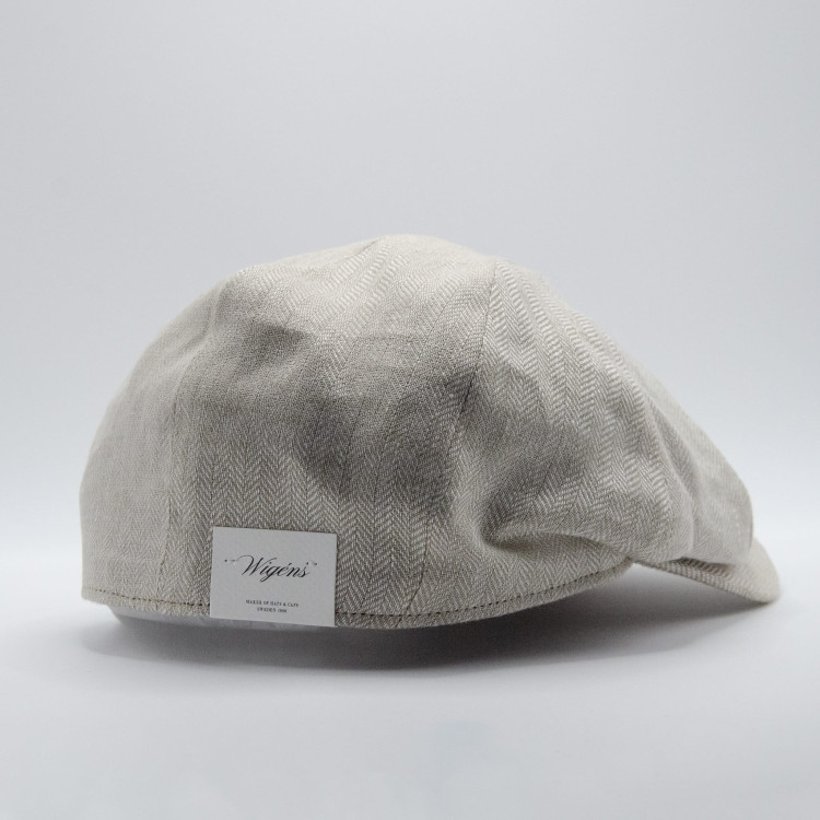Sidovy av ljusbeige Wigéns News Boy Classic Cap med etikett